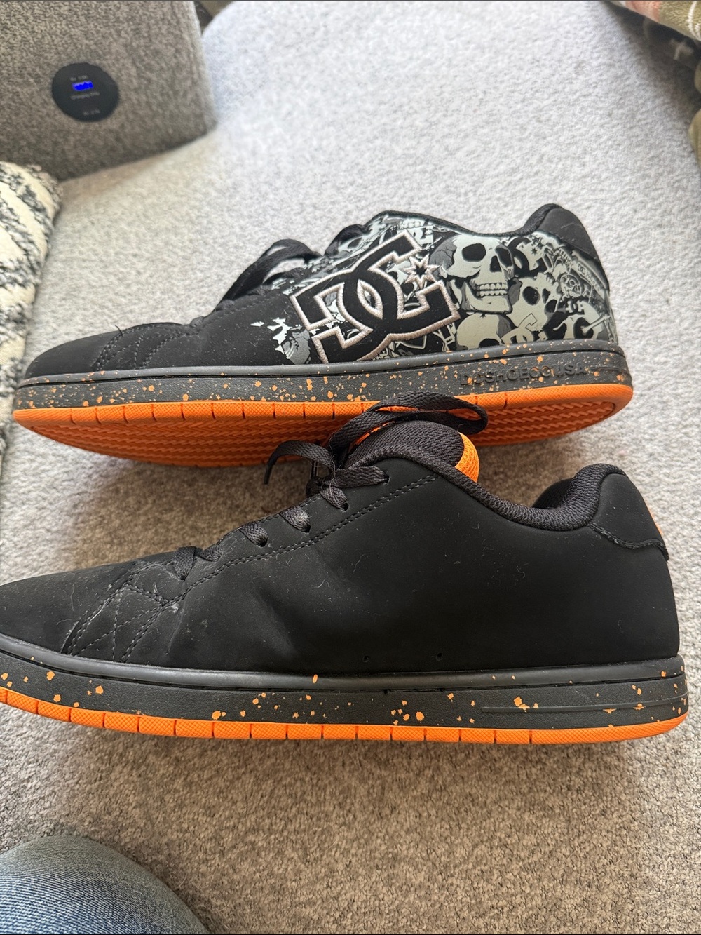 DC Men's Black and Orange Skate Sneakers with Skull Graphic